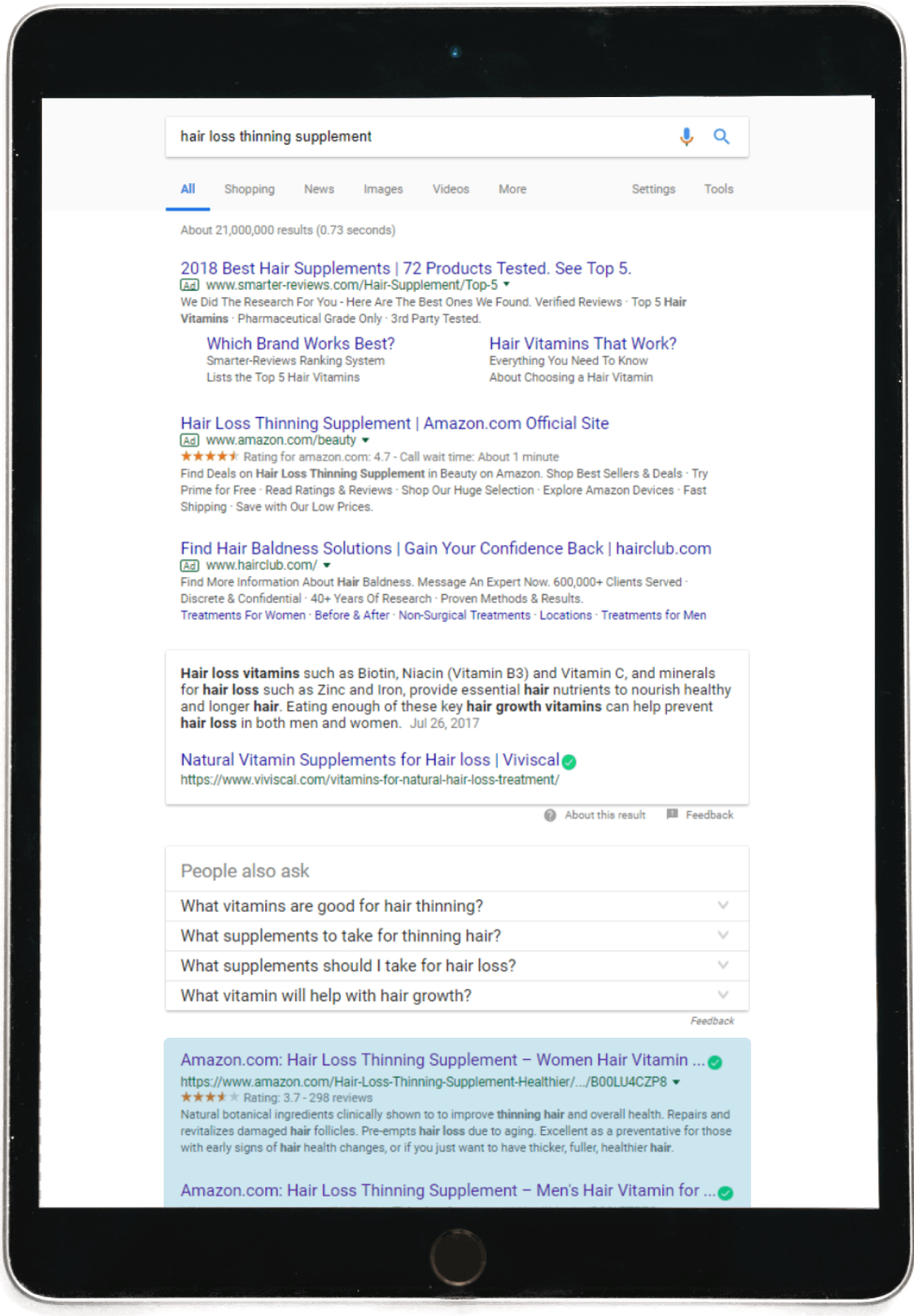 Search results on a tablet of hair loss supplements